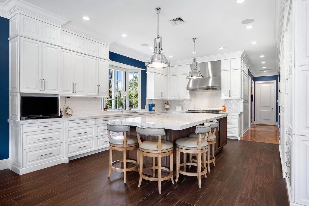 Discover unparalleled luxury at 336 E Coconut Palm Road in the prestigious Royal Palm Yacht & Country Club.