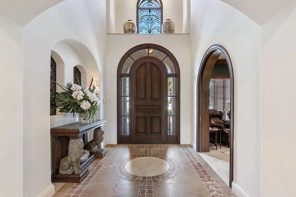 Discover unparalleled luxury at 336 E Coconut Palm Road in the prestigious Royal Palm Yacht & Country Club.