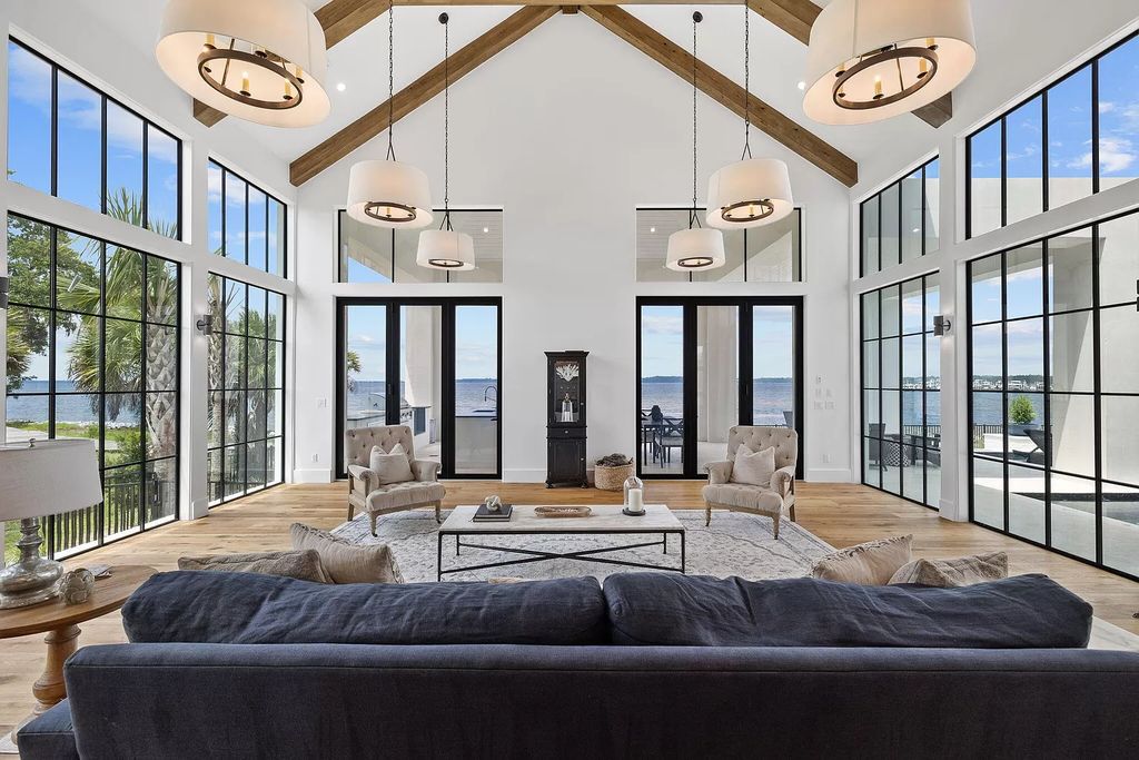 Nestled on a double homesite with 150'+ of Choctawhatchee Bay frontage in the prestigious gated enclave of Churchill Oaks, 51 Junop Court is a stunning legacy residence designed by Matt Savois and built by Grand Bay Construction.