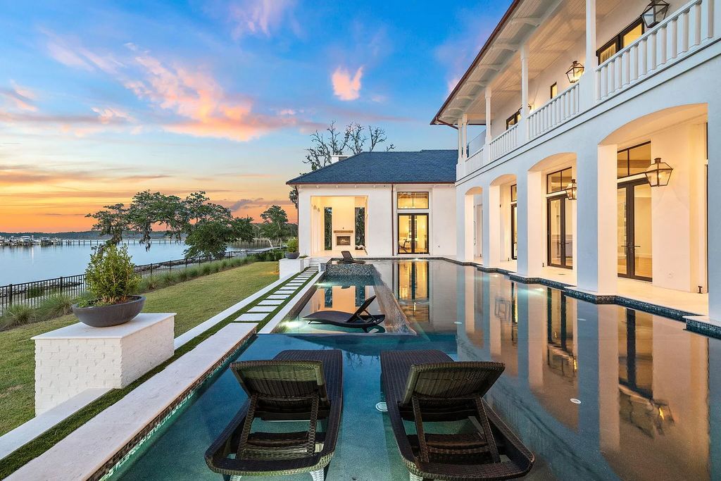 Nestled on a double homesite with 150'+ of Choctawhatchee Bay frontage in the prestigious gated enclave of Churchill Oaks, 51 Junop Court is a stunning legacy residence designed by Matt Savois and built by Grand Bay Construction.