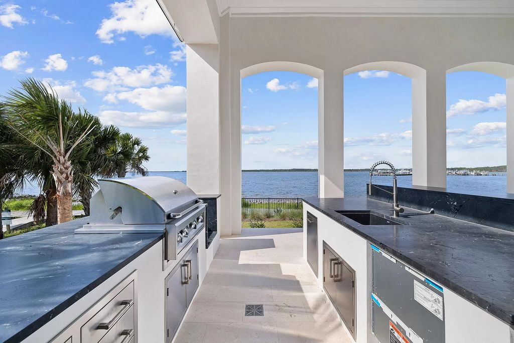 Nestled on a double homesite with 150'+ of Choctawhatchee Bay frontage in the prestigious gated enclave of Churchill Oaks, 51 Junop Court is a stunning legacy residence designed by Matt Savois and built by Grand Bay Construction.