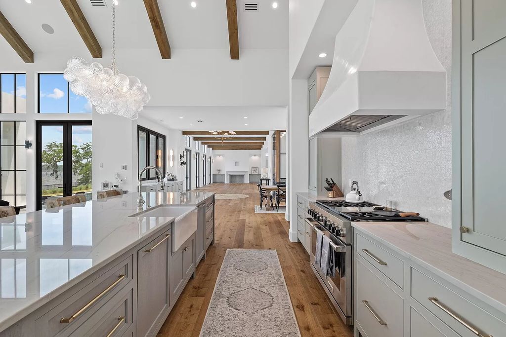 Nestled on a double homesite with 150'+ of Choctawhatchee Bay frontage in the prestigious gated enclave of Churchill Oaks, 51 Junop Court is a stunning legacy residence designed by Matt Savois and built by Grand Bay Construction.