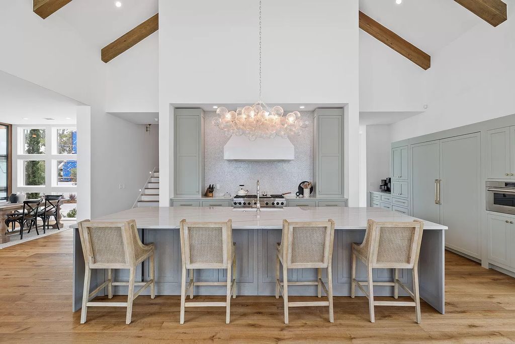 Nestled on a double homesite with 150'+ of Choctawhatchee Bay frontage in the prestigious gated enclave of Churchill Oaks, 51 Junop Court is a stunning legacy residence designed by Matt Savois and built by Grand Bay Construction.