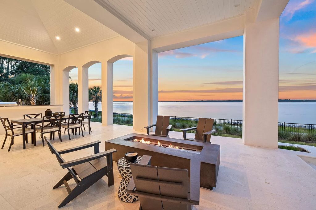 Nestled on a double homesite with 150'+ of Choctawhatchee Bay frontage in the prestigious gated enclave of Churchill Oaks, 51 Junop Court is a stunning legacy residence designed by Matt Savois and built by Grand Bay Construction.