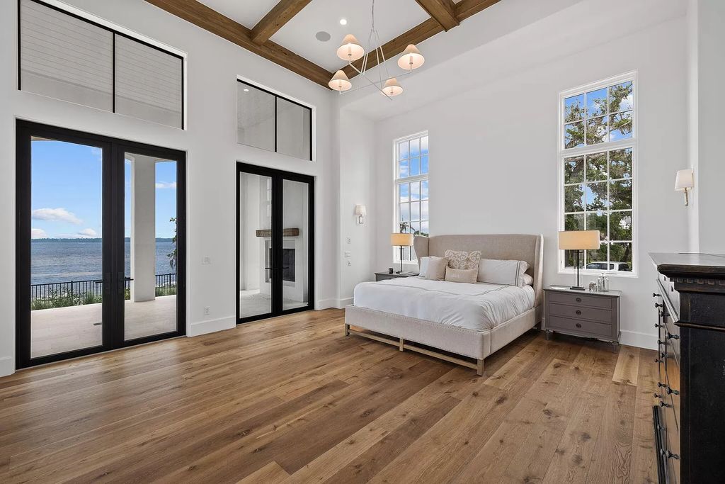 Nestled on a double homesite with 150'+ of Choctawhatchee Bay frontage in the prestigious gated enclave of Churchill Oaks, 51 Junop Court is a stunning legacy residence designed by Matt Savois and built by Grand Bay Construction.