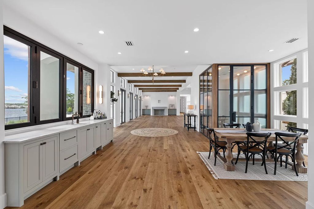 Nestled on a double homesite with 150'+ of Choctawhatchee Bay frontage in the prestigious gated enclave of Churchill Oaks, 51 Junop Court is a stunning legacy residence designed by Matt Savois and built by Grand Bay Construction.