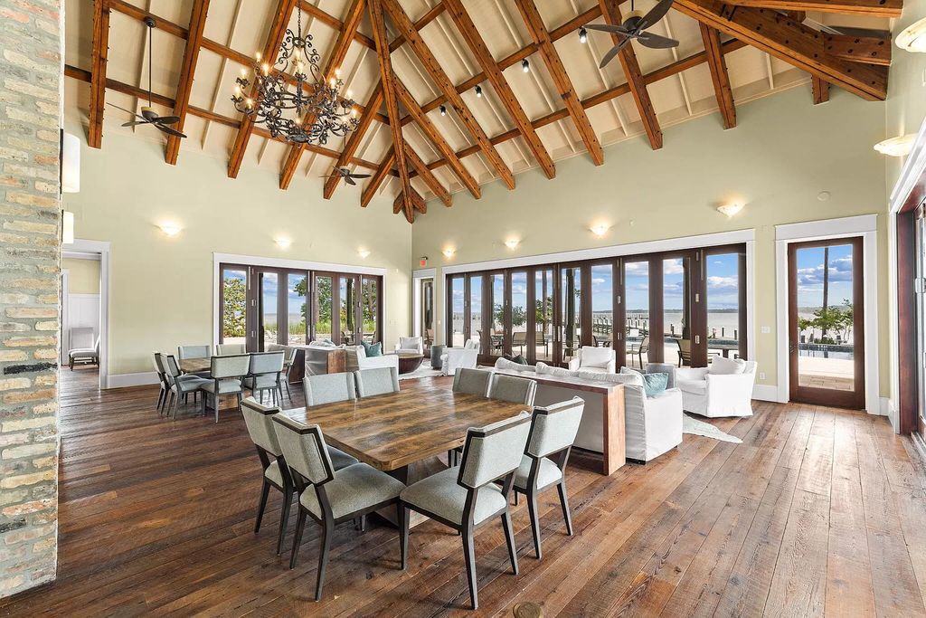 Nestled on a double homesite with 150'+ of Choctawhatchee Bay frontage in the prestigious gated enclave of Churchill Oaks, 51 Junop Court is a stunning legacy residence designed by Matt Savois and built by Grand Bay Construction.