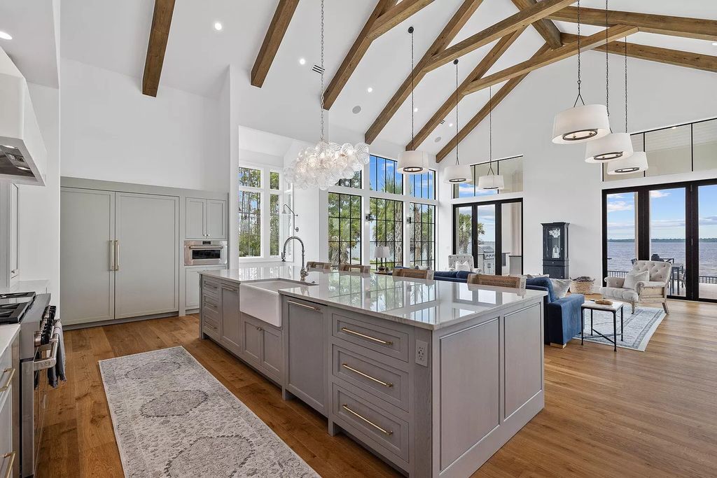 Nestled on a double homesite with 150'+ of Choctawhatchee Bay frontage in the prestigious gated enclave of Churchill Oaks, 51 Junop Court is a stunning legacy residence designed by Matt Savois and built by Grand Bay Construction.