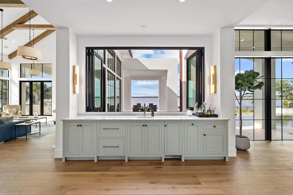 Nestled on a double homesite with 150'+ of Choctawhatchee Bay frontage in the prestigious gated enclave of Churchill Oaks, 51 Junop Court is a stunning legacy residence designed by Matt Savois and built by Grand Bay Construction.