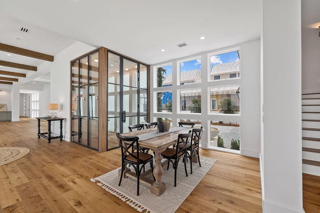 Nestled on a double homesite with 150'+ of Choctawhatchee Bay frontage in the prestigious gated enclave of Churchill Oaks, 51 Junop Court is a stunning legacy residence designed by Matt Savois and built by Grand Bay Construction.