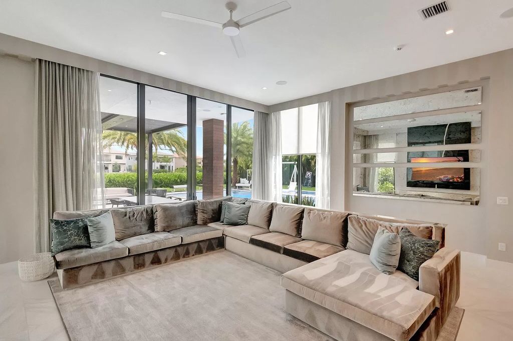 Welcome to this lavish modern luxury estate in the prestigious Boca Bridges. This distinguished "Dali" contemporary masterpiece, one of only seven, spans 8,000 square feet on a large waterfront lot.