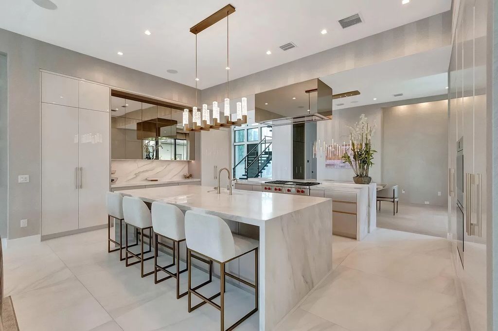 Welcome to this lavish modern luxury estate in the prestigious Boca Bridges. This distinguished "Dali" contemporary masterpiece, one of only seven, spans 8,000 square feet on a large waterfront lot.