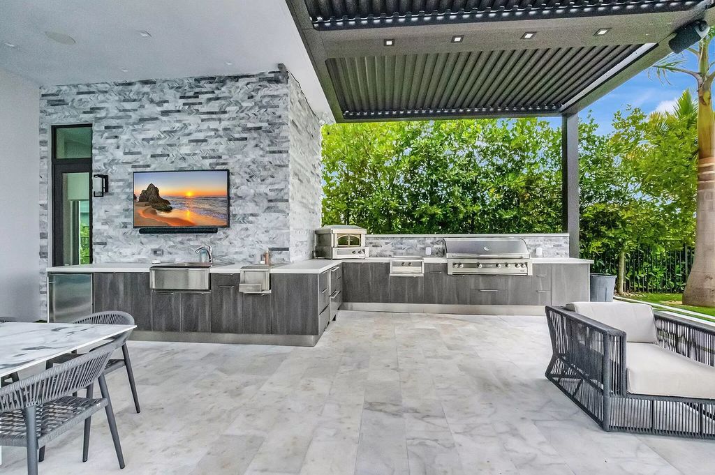 Welcome to this lavish modern luxury estate in the prestigious Boca Bridges. This distinguished "Dali" contemporary masterpiece, one of only seven, spans 8,000 square feet on a large waterfront lot.