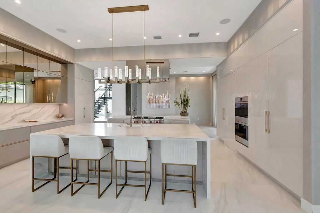 Welcome to this lavish modern luxury estate in the prestigious Boca Bridges. This distinguished "Dali" contemporary masterpiece, one of only seven, spans 8,000 square feet on a large waterfront lot.
