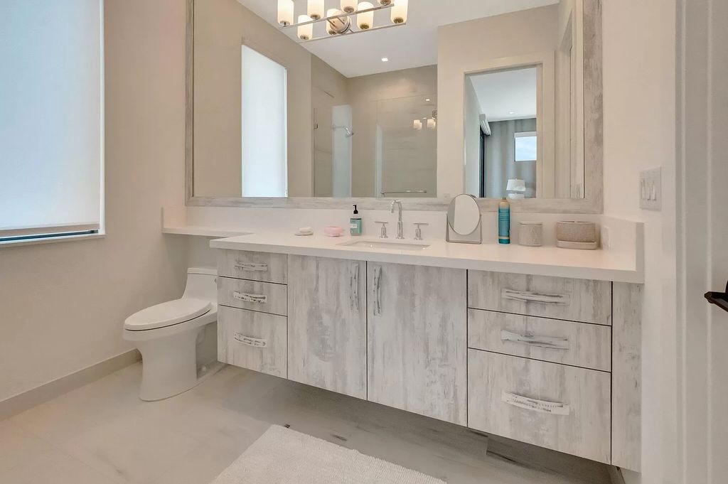 Welcome to this lavish modern luxury estate in the prestigious Boca Bridges. This distinguished "Dali" contemporary masterpiece, one of only seven, spans 8,000 square feet on a large waterfront lot.