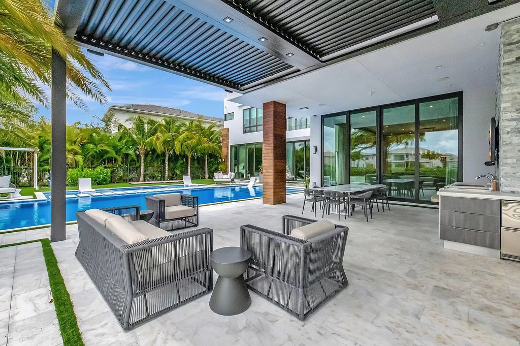 Welcome to this lavish modern luxury estate in the prestigious Boca Bridges. This distinguished "Dali" contemporary masterpiece, one of only seven, spans 8,000 square feet on a large waterfront lot.