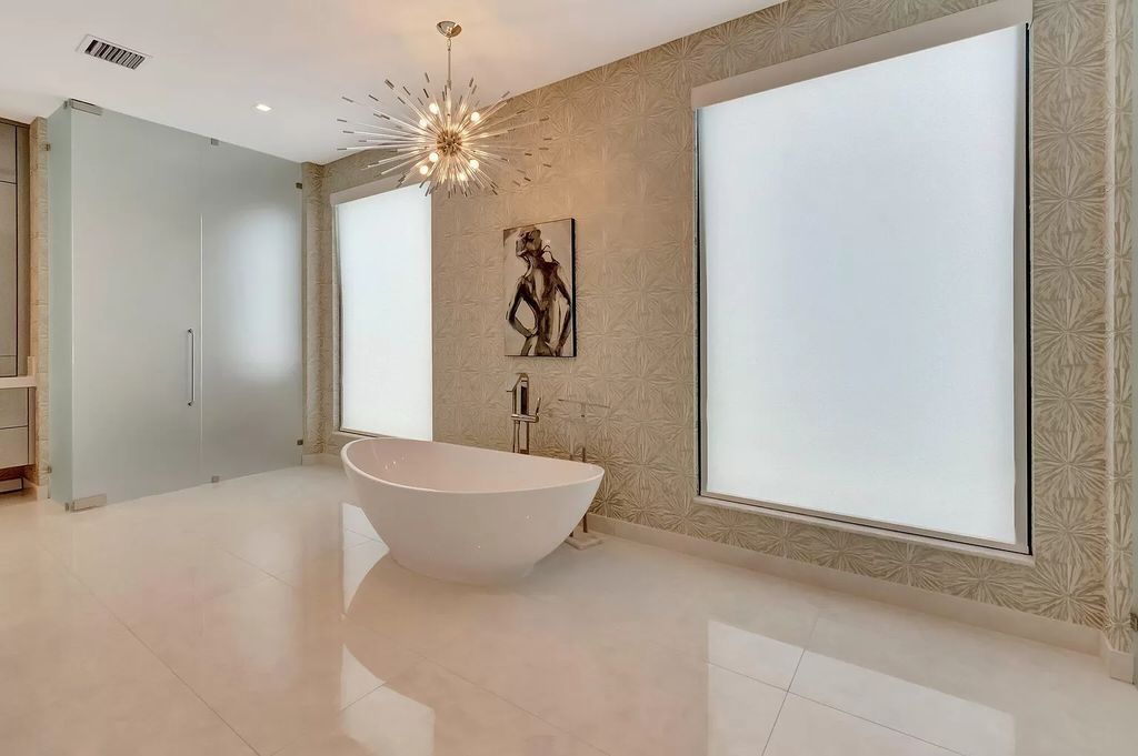 Welcome to this lavish modern luxury estate in the prestigious Boca Bridges. This distinguished "Dali" contemporary masterpiece, one of only seven, spans 8,000 square feet on a large waterfront lot.