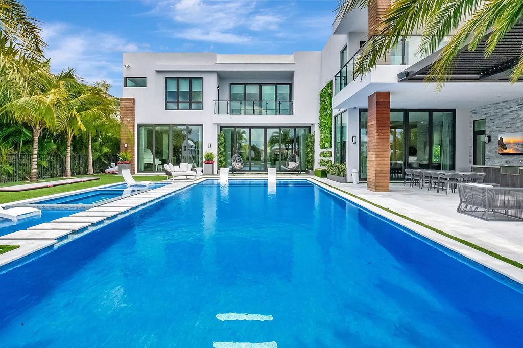 Welcome to this lavish modern luxury estate in the prestigious Boca Bridges. This distinguished "Dali" contemporary masterpiece, one of only seven, spans 8,000 square feet on a large waterfront lot.