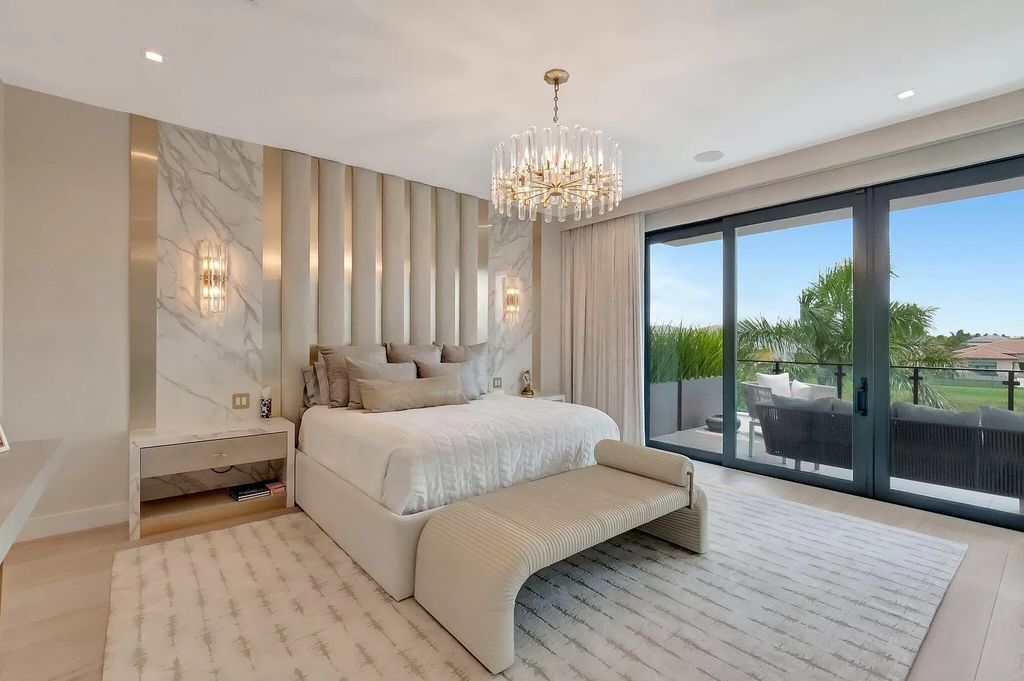 Welcome to this lavish modern luxury estate in the prestigious Boca Bridges. This distinguished "Dali" contemporary masterpiece, one of only seven, spans 8,000 square feet on a large waterfront lot.