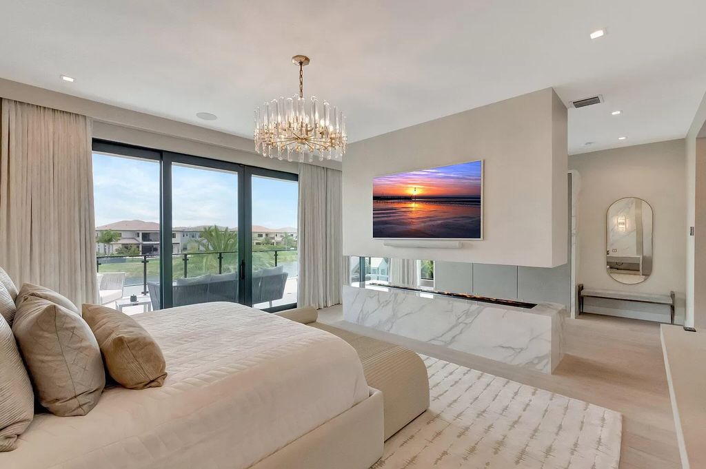 Welcome to this lavish modern luxury estate in the prestigious Boca Bridges. This distinguished "Dali" contemporary masterpiece, one of only seven, spans 8,000 square feet on a large waterfront lot.