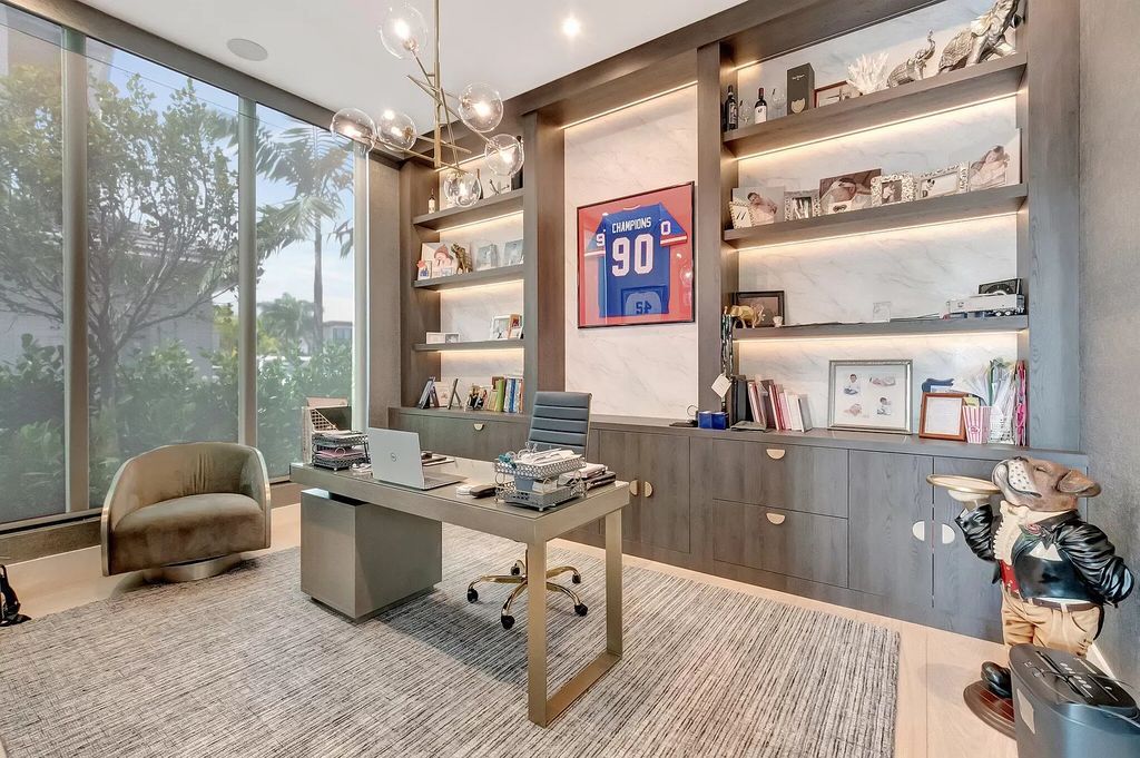 Welcome to this lavish modern luxury estate in the prestigious Boca Bridges. This distinguished "Dali" contemporary masterpiece, one of only seven, spans 8,000 square feet on a large waterfront lot.