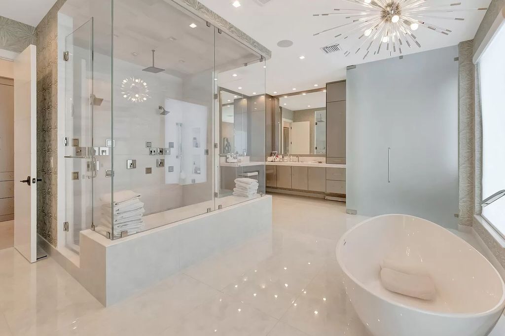 Welcome to this lavish modern luxury estate in the prestigious Boca Bridges. This distinguished "Dali" contemporary masterpiece, one of only seven, spans 8,000 square feet on a large waterfront lot.