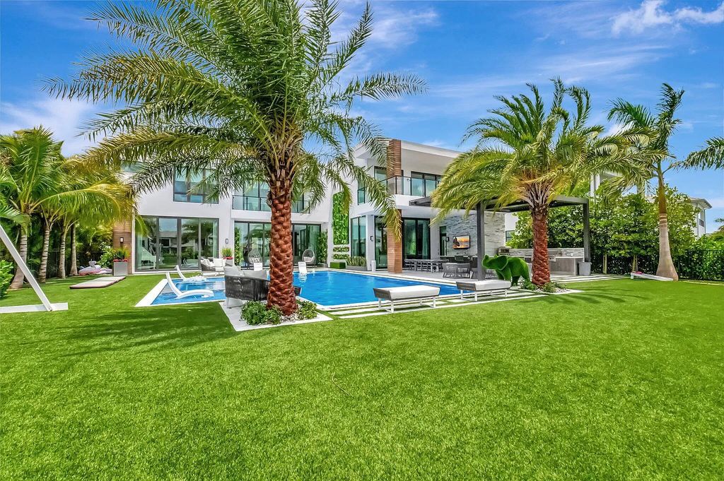 Welcome to this lavish modern luxury estate in the prestigious Boca Bridges. This distinguished "Dali" contemporary masterpiece, one of only seven, spans 8,000 square feet on a large waterfront lot.