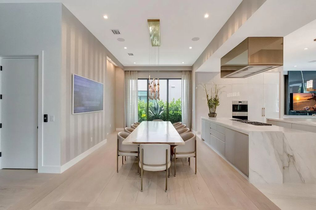 Welcome to this lavish modern luxury estate in the prestigious Boca Bridges. This distinguished "Dali" contemporary masterpiece, one of only seven, spans 8,000 square feet on a large waterfront lot.