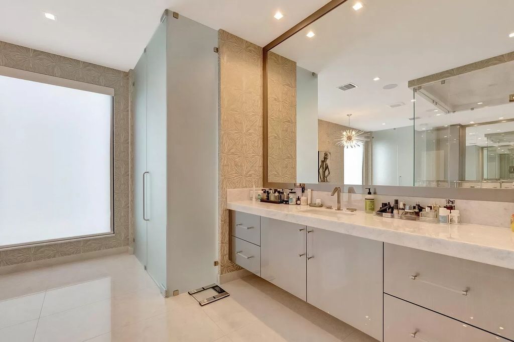 Welcome to this lavish modern luxury estate in the prestigious Boca Bridges. This distinguished "Dali" contemporary masterpiece, one of only seven, spans 8,000 square feet on a large waterfront lot.