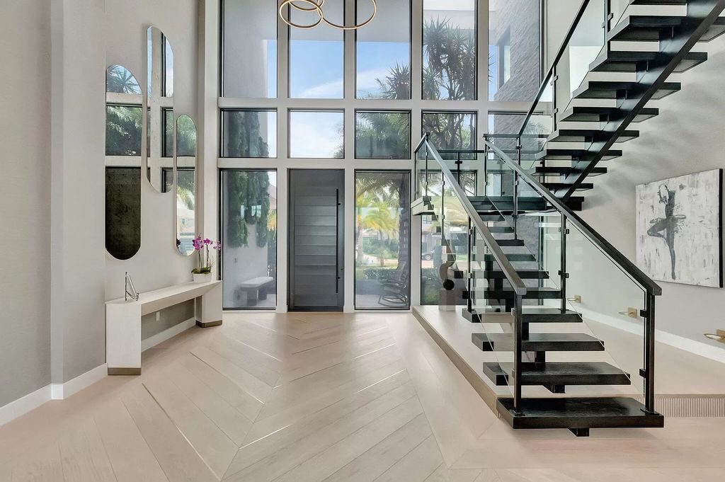 Welcome to this lavish modern luxury estate in the prestigious Boca Bridges. This distinguished "Dali" contemporary masterpiece, one of only seven, spans 8,000 square feet on a large waterfront lot.