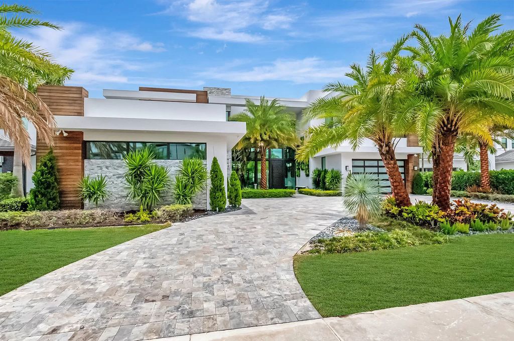 Welcome to this lavish modern luxury estate in the prestigious Boca Bridges. This distinguished "Dali" contemporary masterpiece, one of only seven, spans 8,000 square feet on a large waterfront lot.