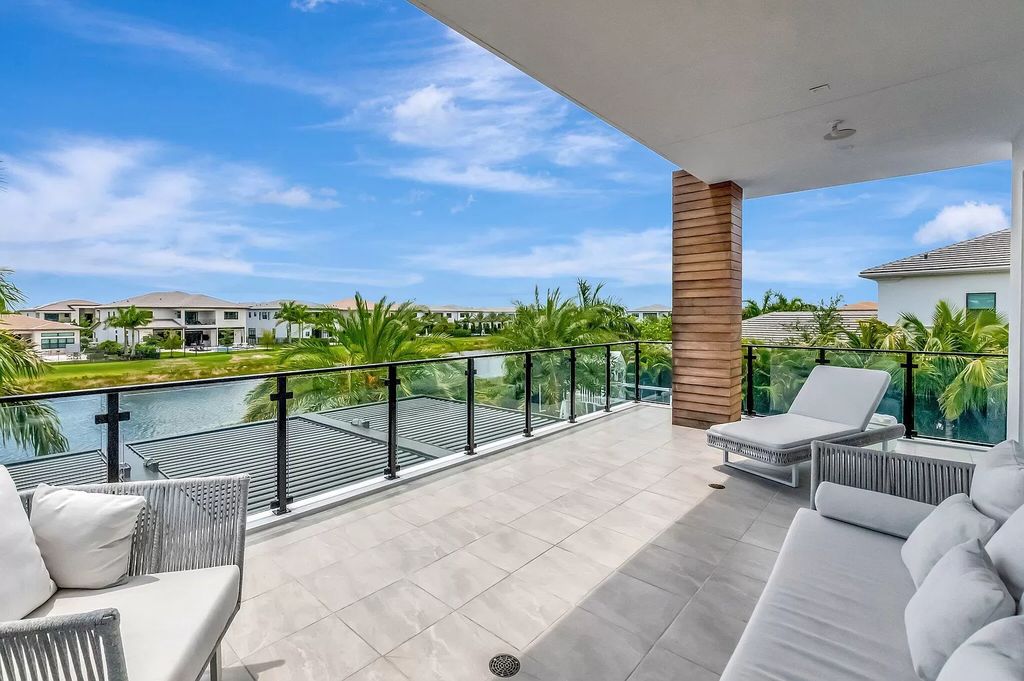 Welcome to this lavish modern luxury estate in the prestigious Boca Bridges. This distinguished "Dali" contemporary masterpiece, one of only seven, spans 8,000 square feet on a large waterfront lot.