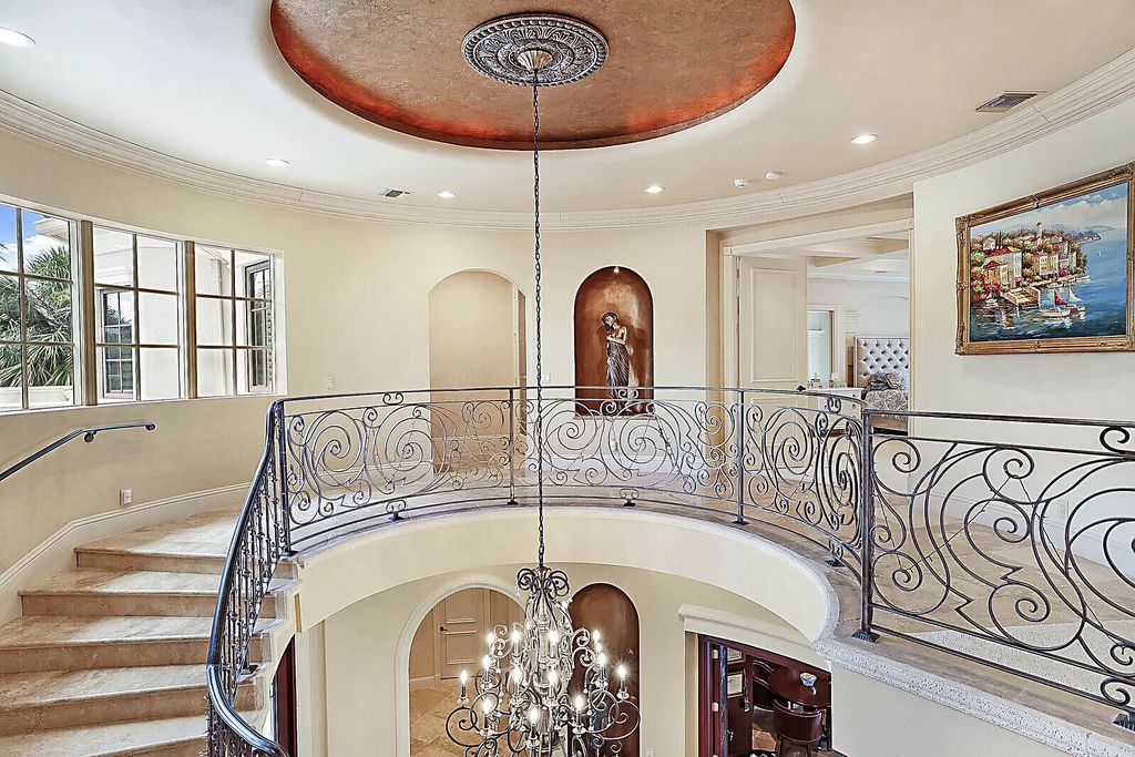 This dream home features a home office, theater, chef's kitchen with high-end appliances, dual-zone wine refrigerators, and lavish architectural details.