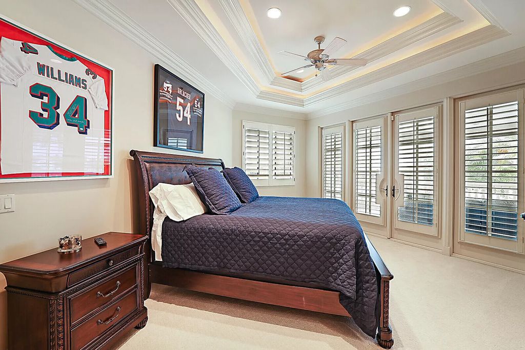 This dream home features a home office, theater, chef's kitchen with high-end appliances, dual-zone wine refrigerators, and lavish architectural details.