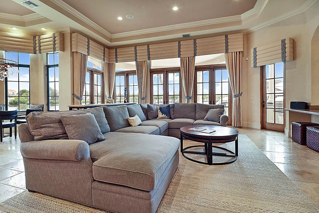 This dream home features a home office, theater, chef's kitchen with high-end appliances, dual-zone wine refrigerators, and lavish architectural details.