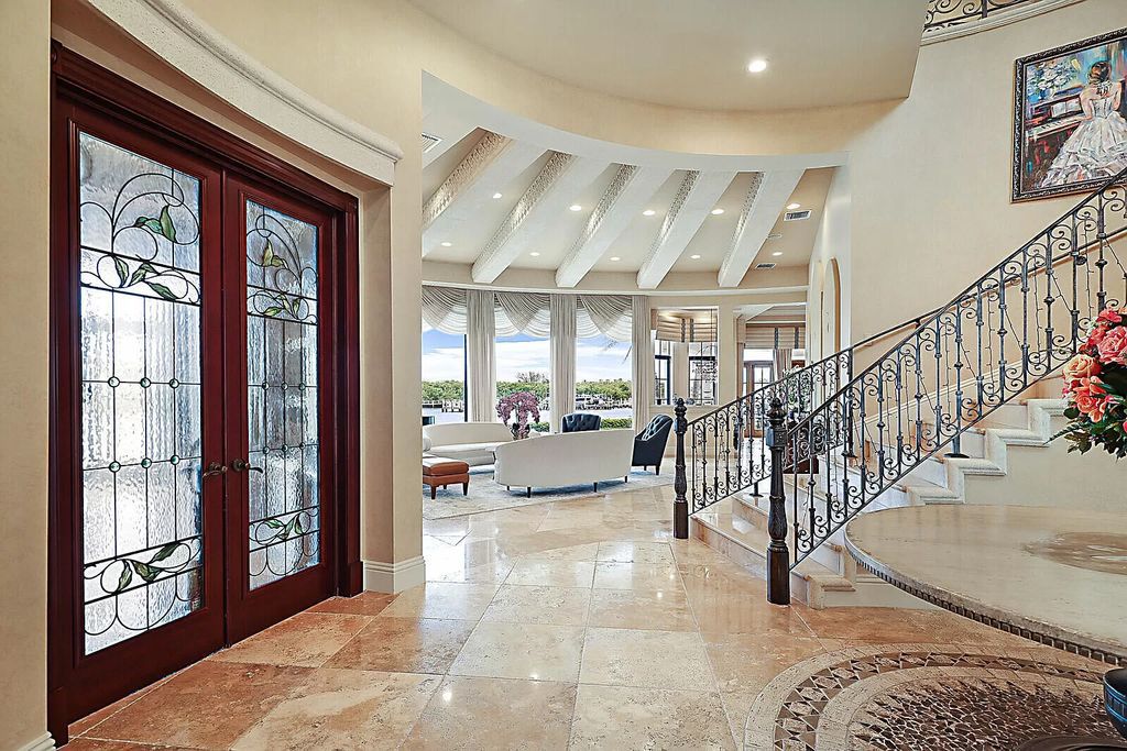 This dream home features a home office, theater, chef's kitchen with high-end appliances, dual-zone wine refrigerators, and lavish architectural details.