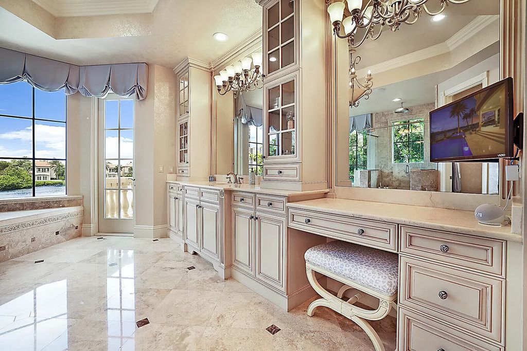 This dream home features a home office, theater, chef's kitchen with high-end appliances, dual-zone wine refrigerators, and lavish architectural details.