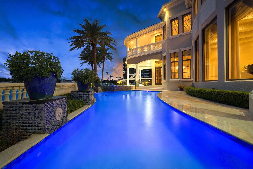 This dream home features a home office, theater, chef's kitchen with high-end appliances, dual-zone wine refrigerators, and lavish architectural details.