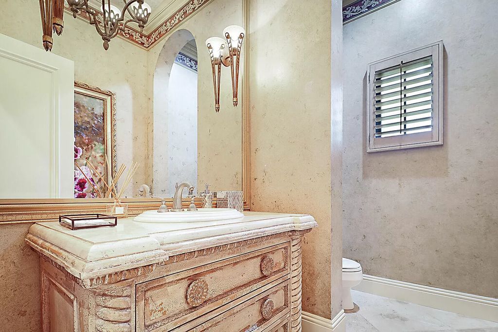This dream home features a home office, theater, chef's kitchen with high-end appliances, dual-zone wine refrigerators, and lavish architectural details.