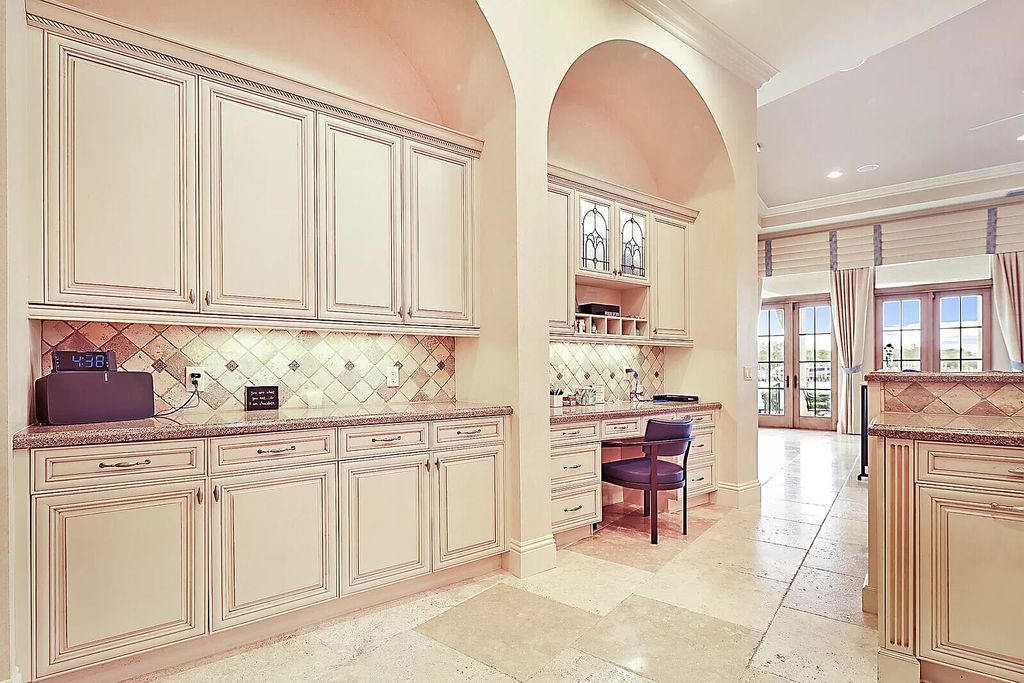 This dream home features a home office, theater, chef's kitchen with high-end appliances, dual-zone wine refrigerators, and lavish architectural details.