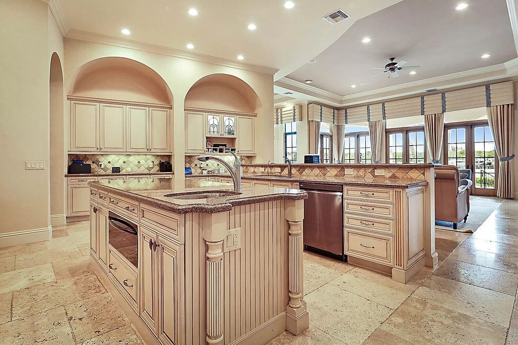 This dream home features a home office, theater, chef's kitchen with high-end appliances, dual-zone wine refrigerators, and lavish architectural details.