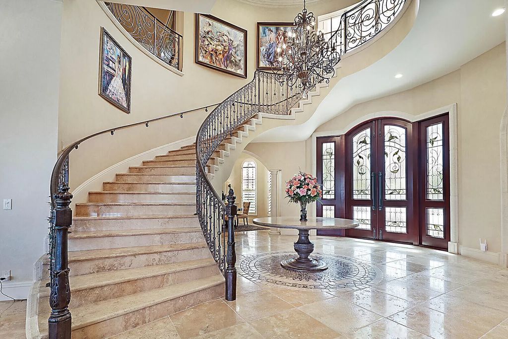 This dream home features a home office, theater, chef's kitchen with high-end appliances, dual-zone wine refrigerators, and lavish architectural details.