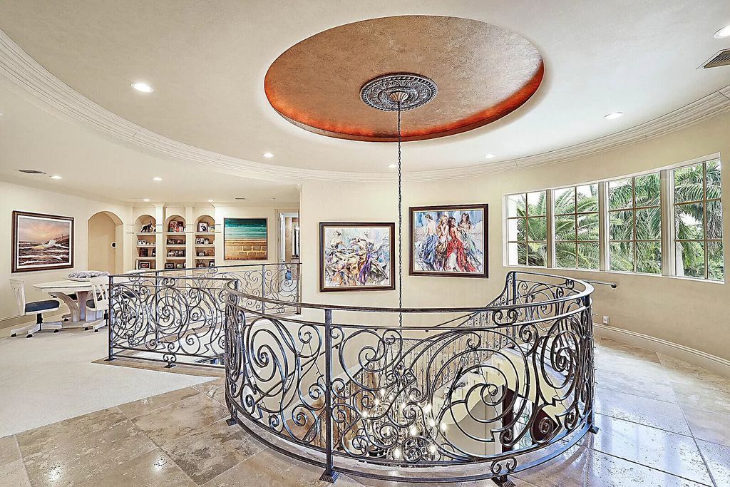 This dream home features a home office, theater, chef's kitchen with high-end appliances, dual-zone wine refrigerators, and lavish architectural details.
