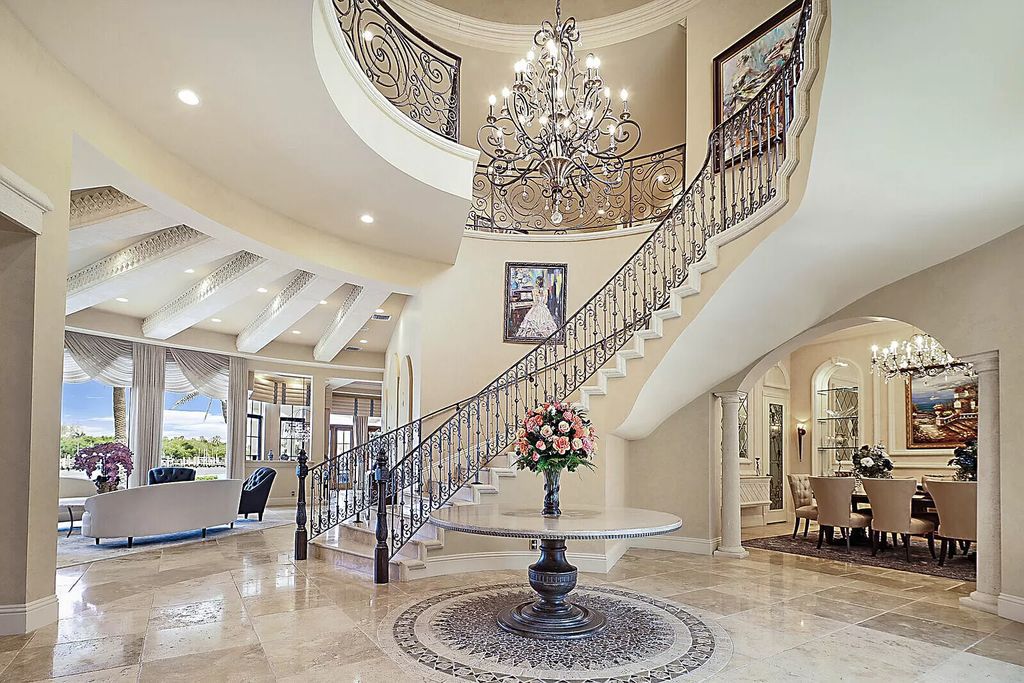 This dream home features a home office, theater, chef's kitchen with high-end appliances, dual-zone wine refrigerators, and lavish architectural details.