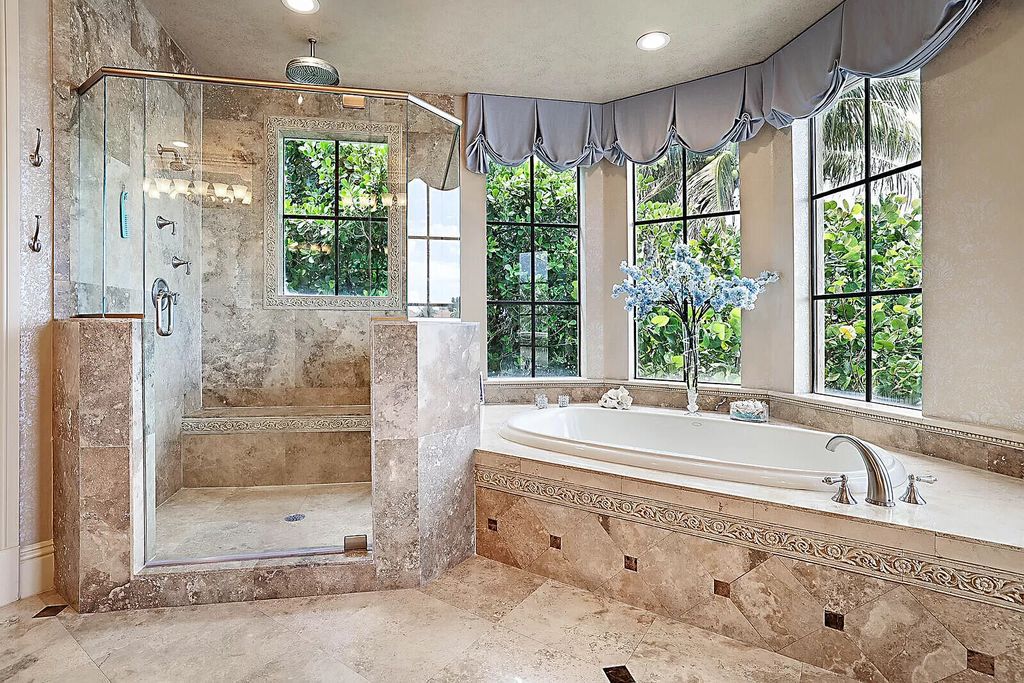 This dream home features a home office, theater, chef's kitchen with high-end appliances, dual-zone wine refrigerators, and lavish architectural details.