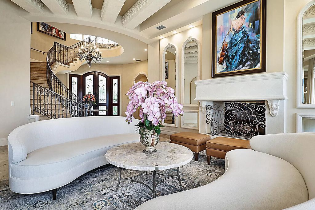 This dream home features a home office, theater, chef's kitchen with high-end appliances, dual-zone wine refrigerators, and lavish architectural details.