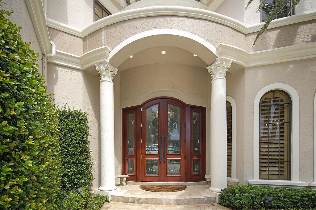 This dream home features a home office, theater, chef's kitchen with high-end appliances, dual-zone wine refrigerators, and lavish architectural details.