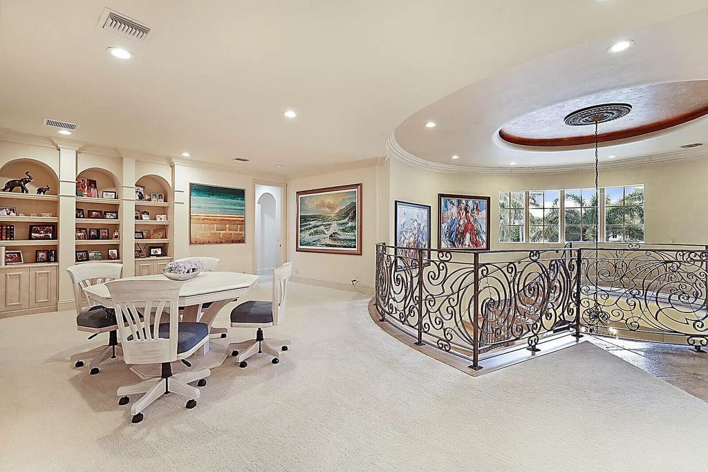 This dream home features a home office, theater, chef's kitchen with high-end appliances, dual-zone wine refrigerators, and lavish architectural details.