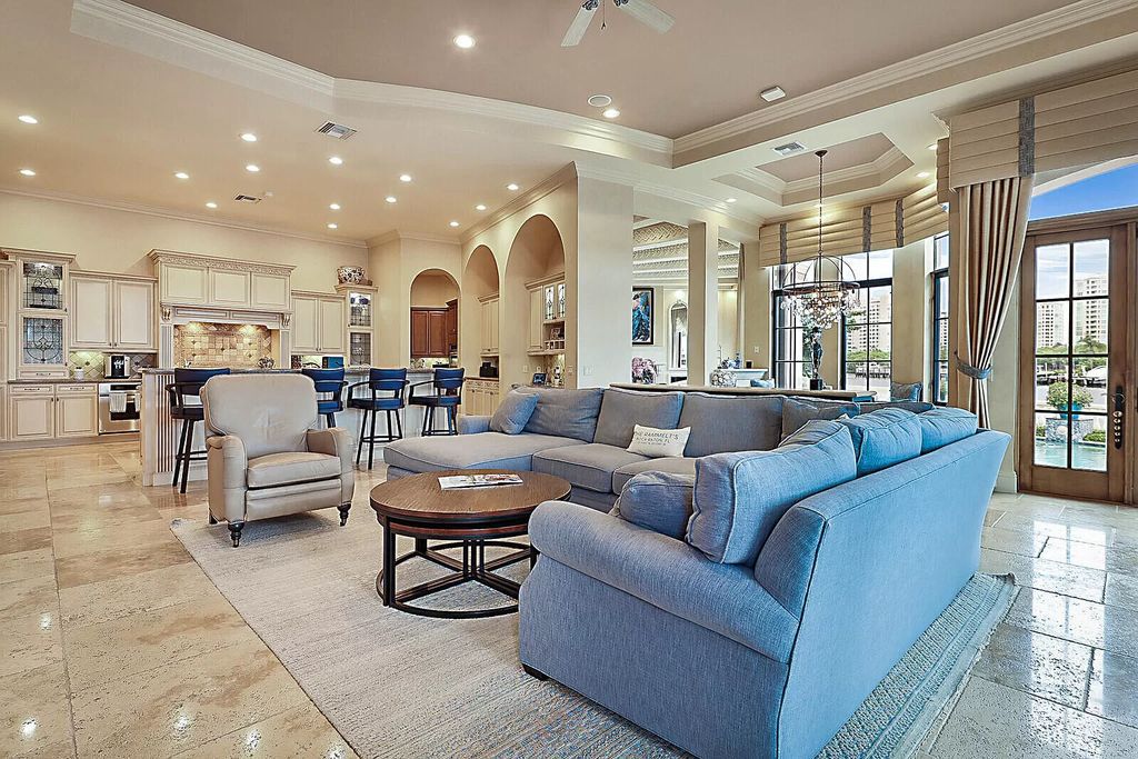 This dream home features a home office, theater, chef's kitchen with high-end appliances, dual-zone wine refrigerators, and lavish architectural details.