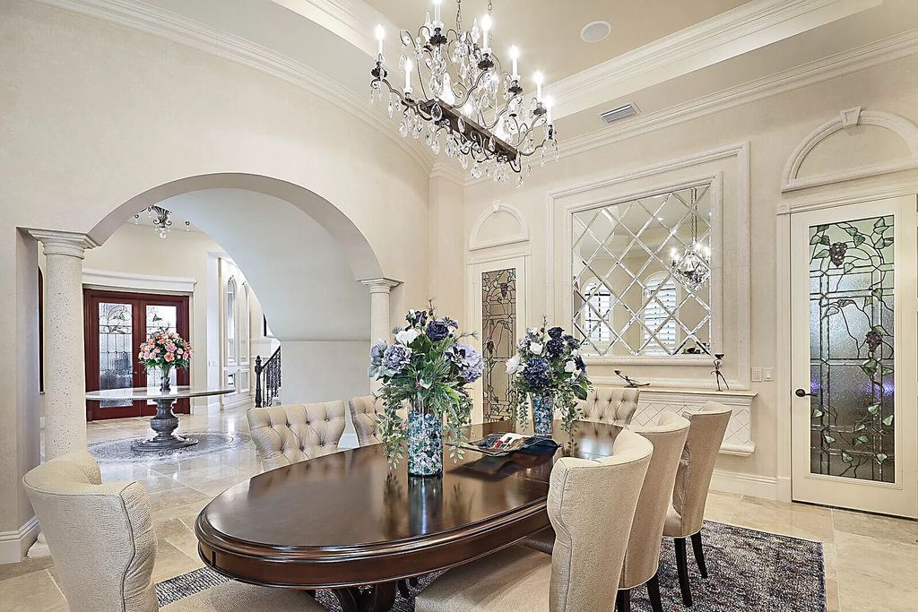 This dream home features a home office, theater, chef's kitchen with high-end appliances, dual-zone wine refrigerators, and lavish architectural details.